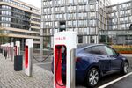 A Model Y electric sports utility vehicle recharging at a supercharger station in central Berlin.
