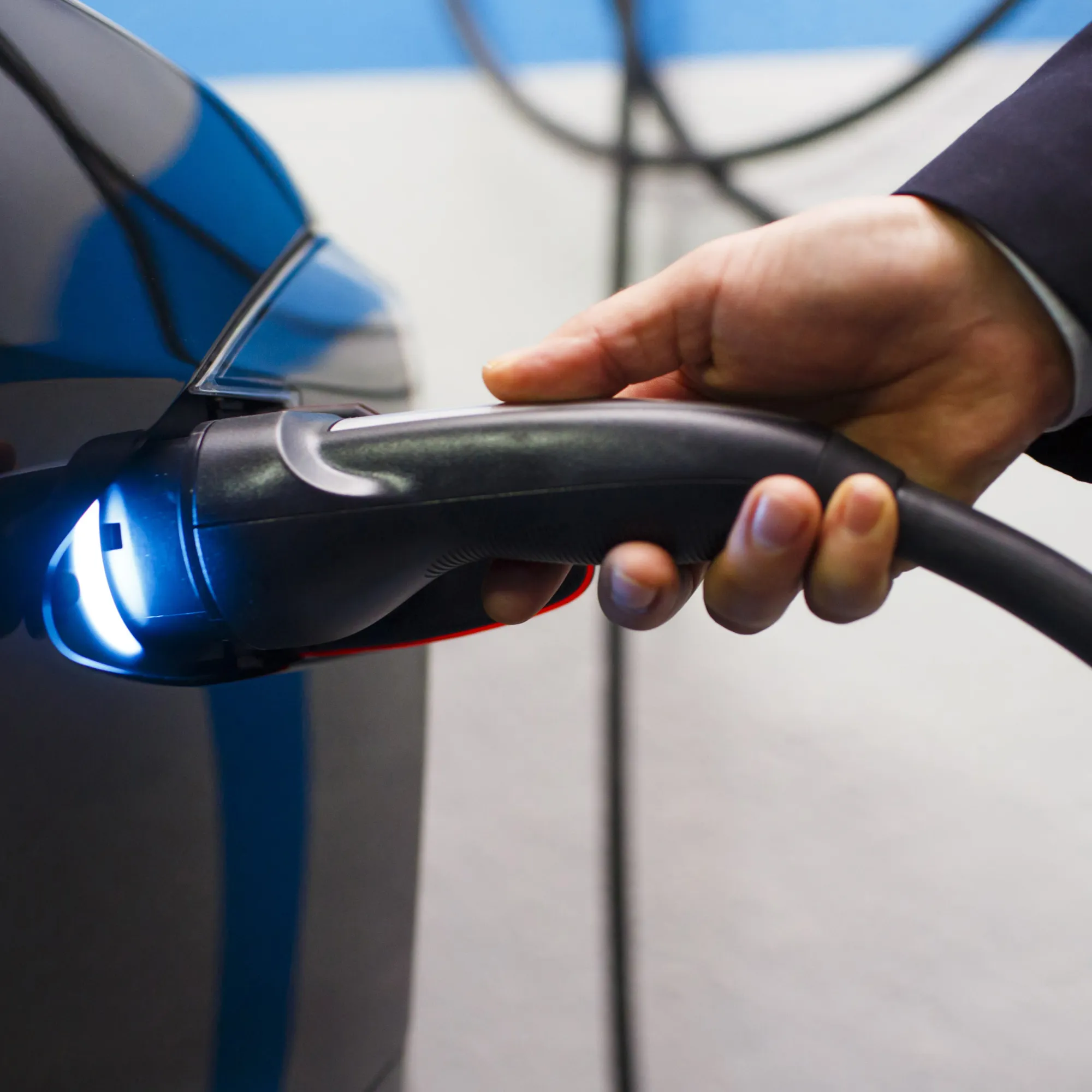 An Uber Technologies Inc. driver plugs a charging cable into a Tesla Motors Inc. Model S electric automobile at a charging point at the InterContinental Hotel in Madrid, Spain, on Friday, Jan. 13, 2017. Ride-hailing service Uber Technologies has launched its first electric car taxi service in Madrid, operating a fleet of Tesla Model S electric vehicles.