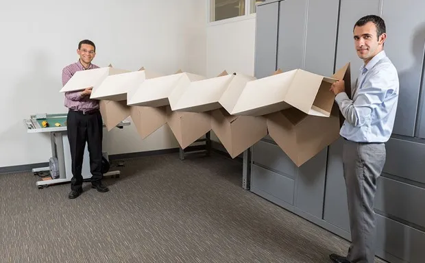 Engineers Glaucio Paulino and Evgueni Filipov with prototypes of their "zippered tubes."