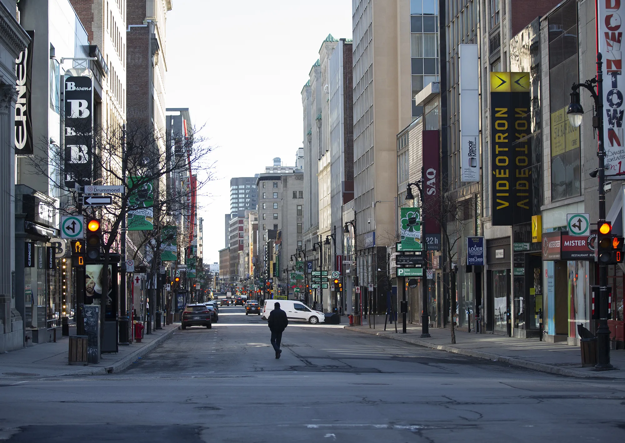 A pedestrian walks down a nearly empty Saint-Catherine Street in Montreal on March 27.