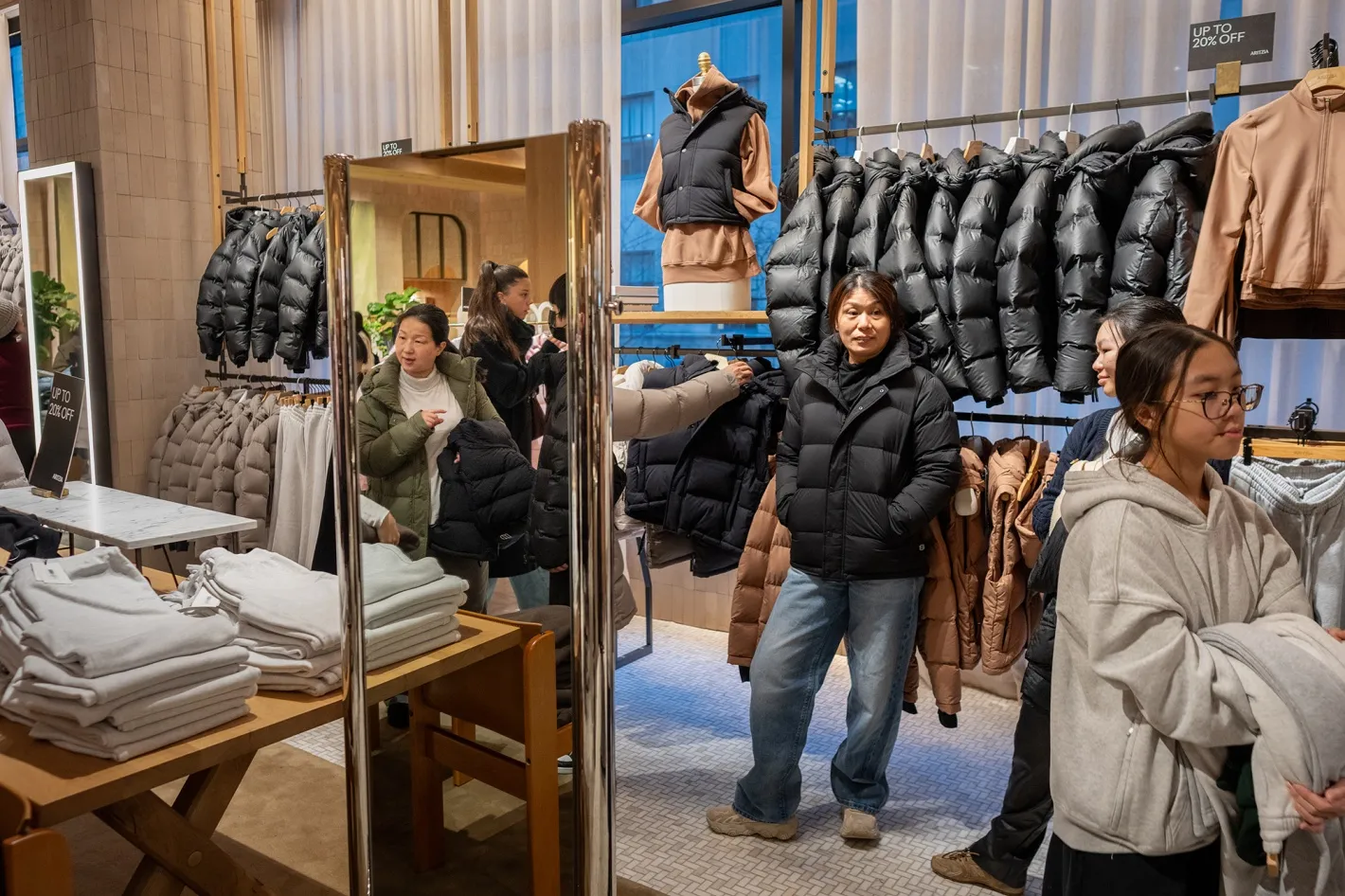Shoppers browse ia store for jackets in New York.