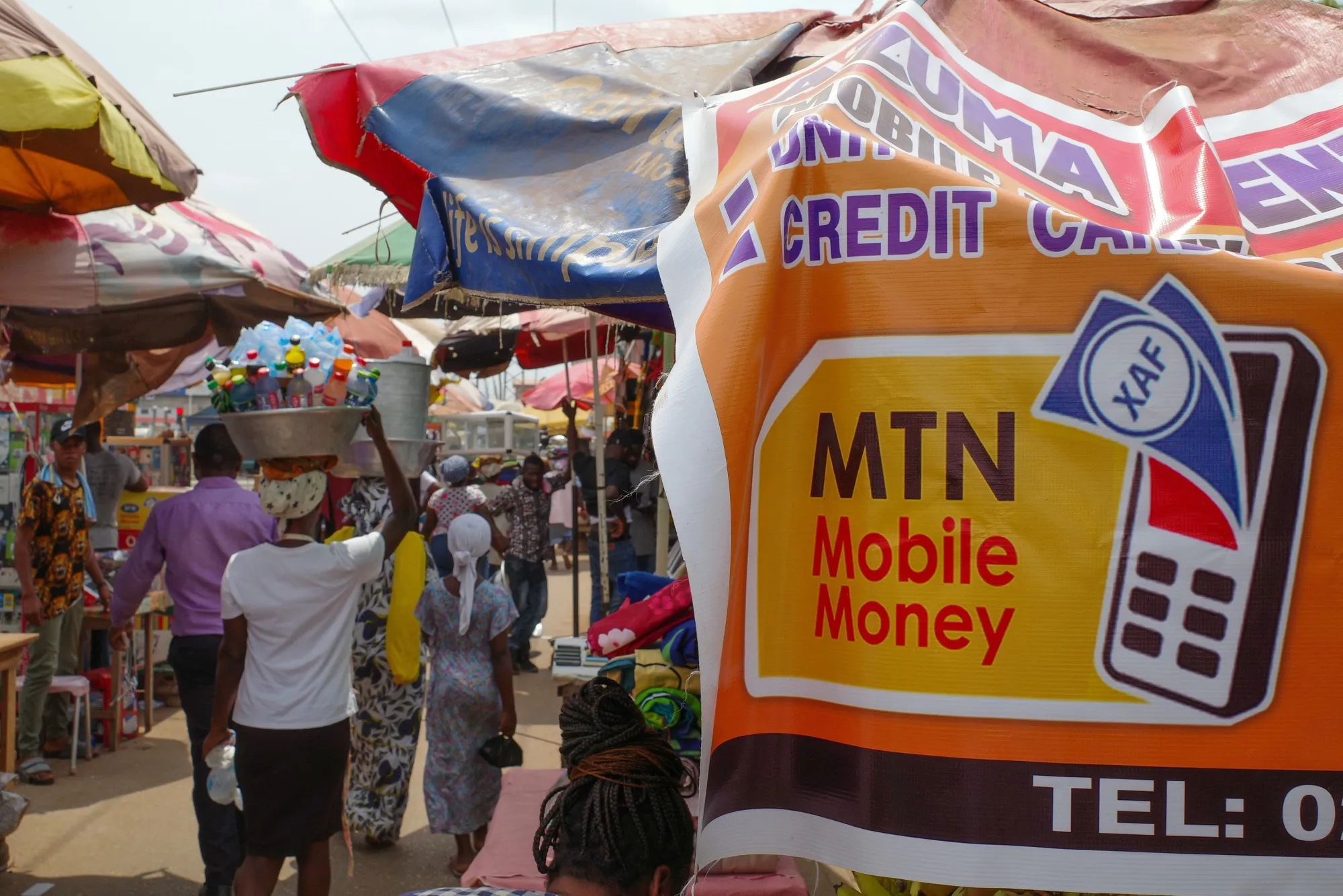 A sign advertising MTN Group&nbsp;mobile money services at a market in Accra, Ghana.