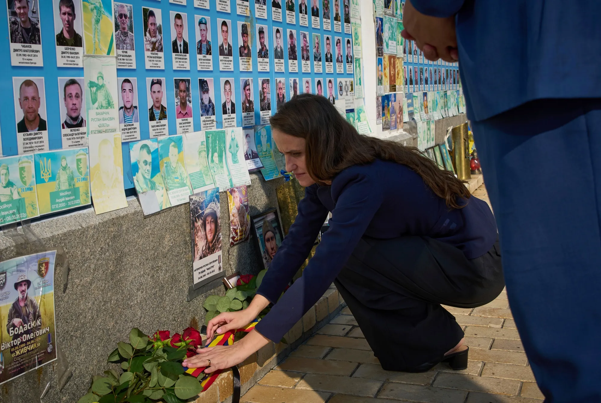 Oana Toiu at a flower laying ceremony at the Memory Wall of Fallen Defenders of Ukraine in Kyiv, on Aug. 7.