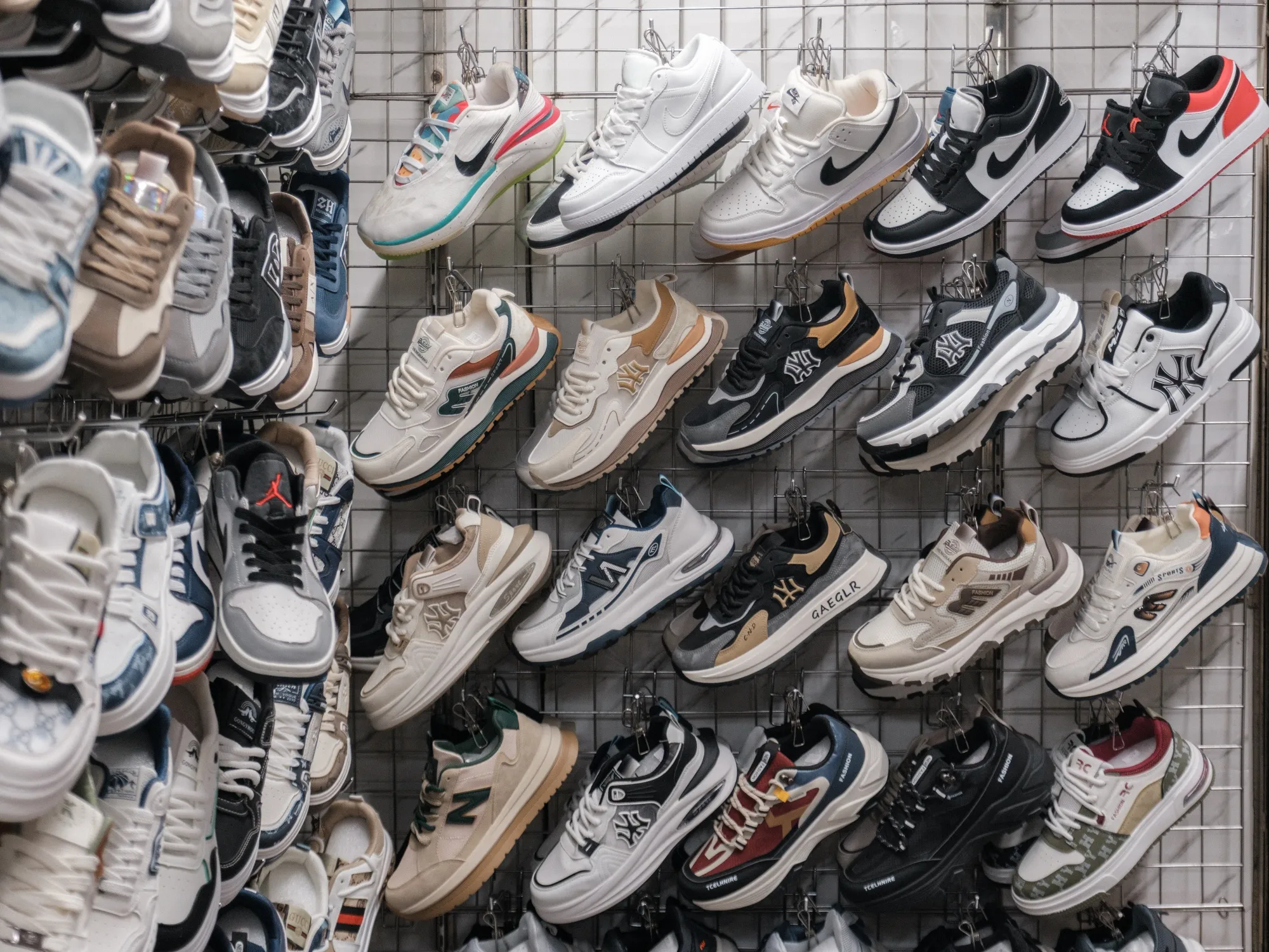 Nike and MLB branded shoes for sale at a stall in Hanoi, Vietnam, on April 12, 2025.