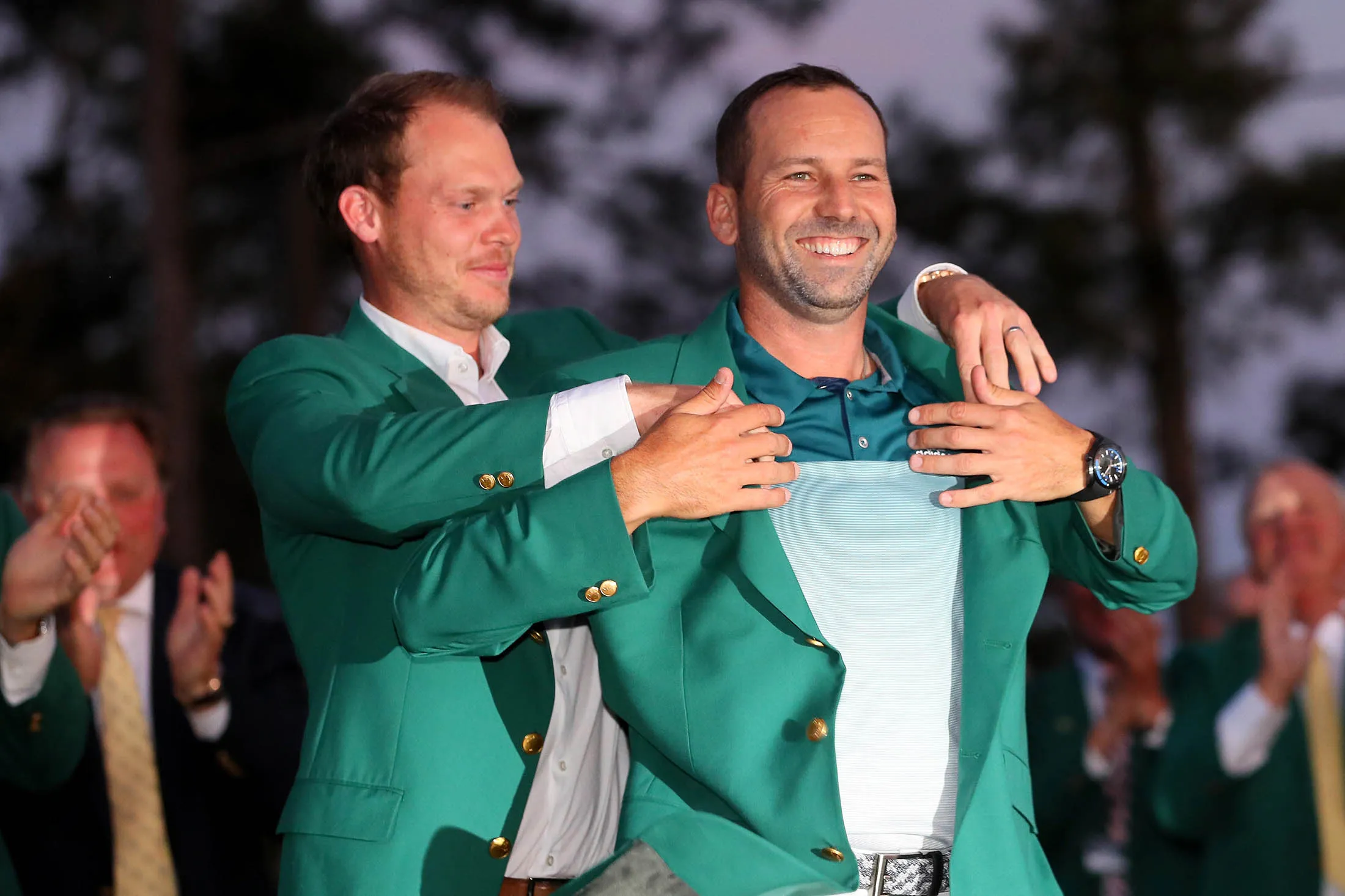 Danny Willett presents Sergio Garcia with the green jacket after Garcia won in a playoff during the final round of the 2017 Masters Tournament at Augusta National Golf Club on April 9.
