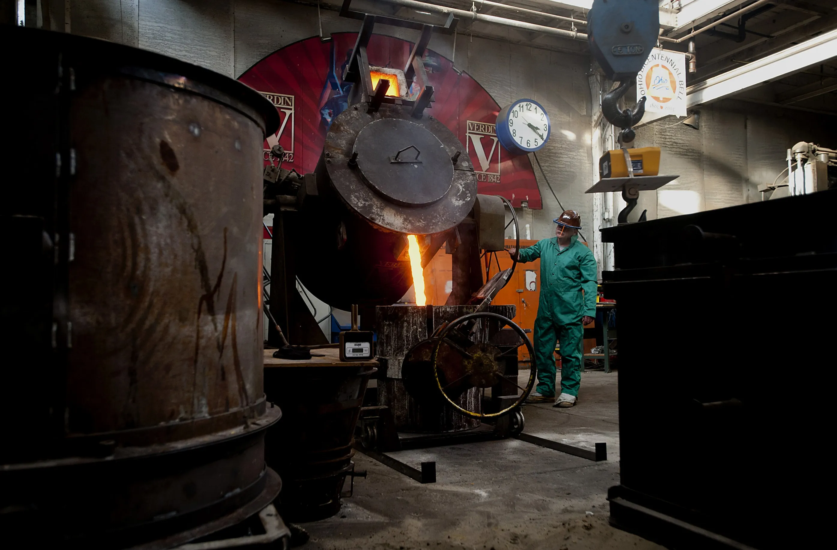 An employee pours molten steel into a casting for a church bell at a production facility in Cincinnatti, Ohio.
