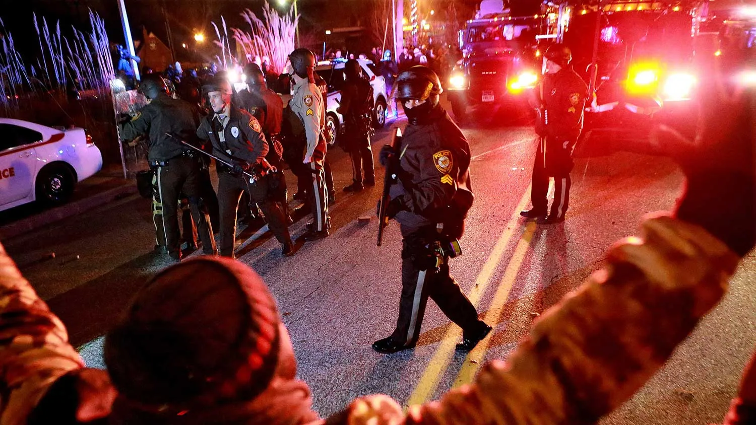 Police and protesters meet at a line on South Florissant Avenue in Ferguson on Monday.

