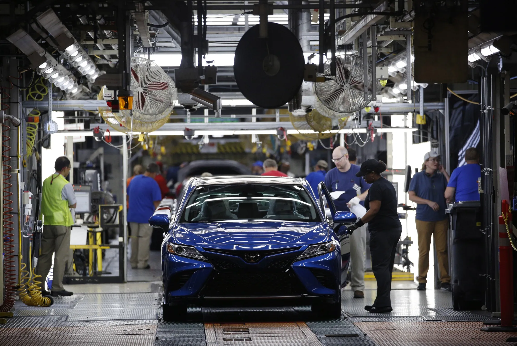Workers inspect vehicles at the Toyota plant in Georgetown, Kentucky, in 2019.