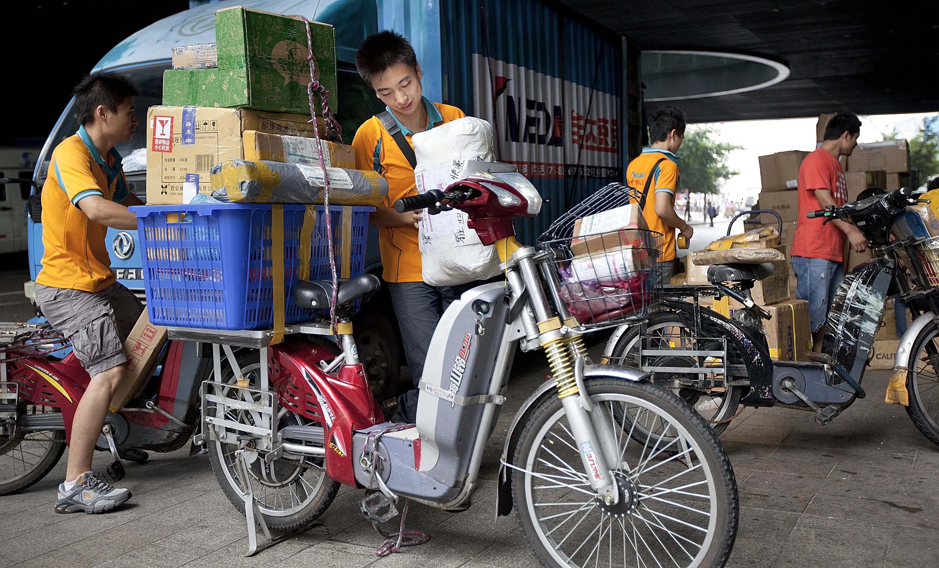 A courier loads packages onto an electric bicycle in Shenzhen, Guangdong Province, China. Some new e-bikes contain less lead as the industry cuts back on costs, according to Beijing Antaike Information & Technology Co.