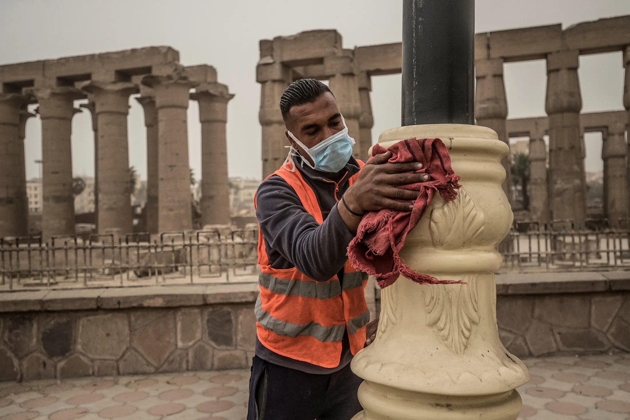 A municipality worker cleans lamp posts outside the Luxor Temple in Egypt's southern city of Luxor on March 12.