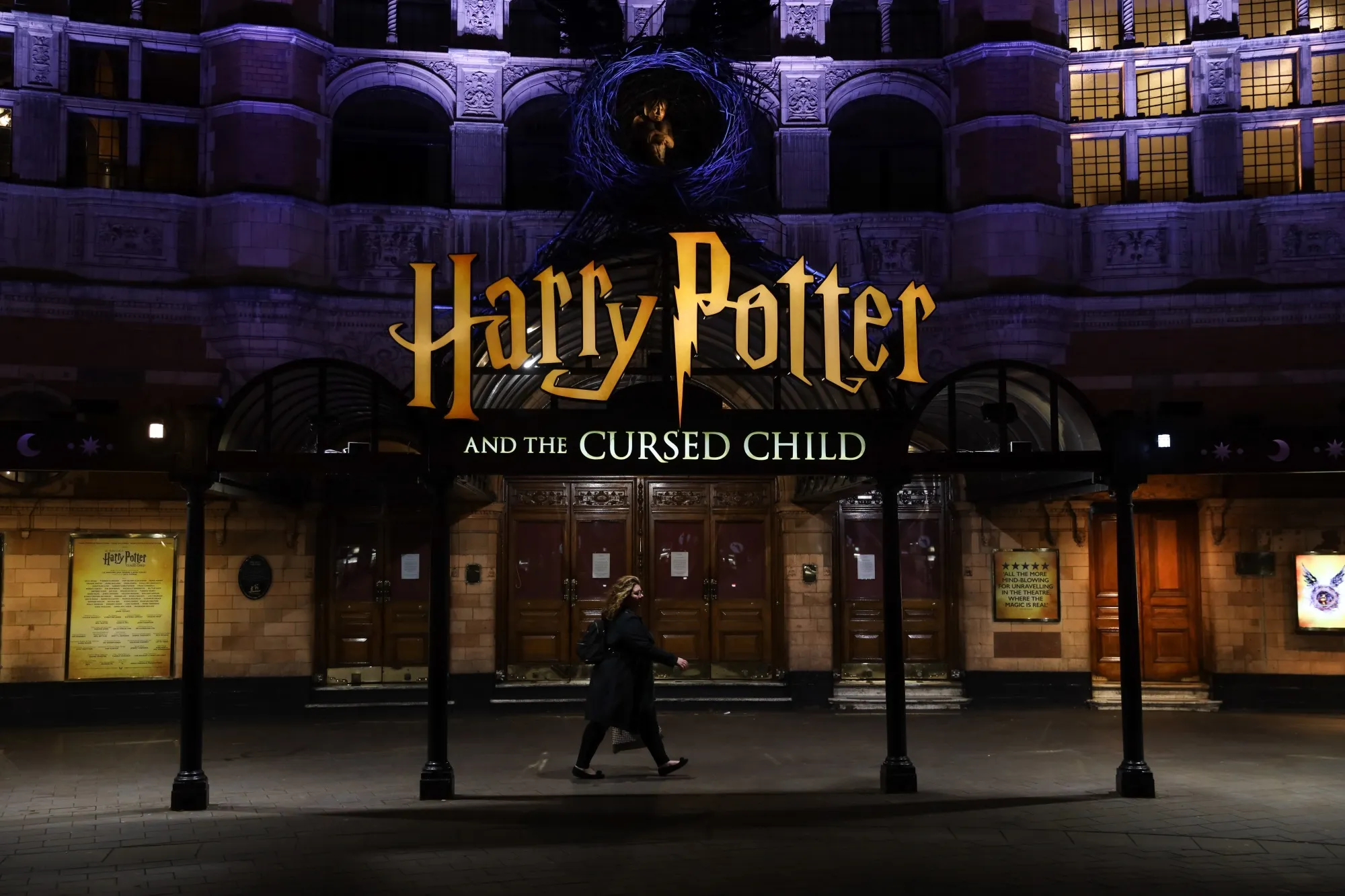 A pedestrian walks past the 'Harry Potter and the Cursed Child' show theatre in the West End district in London, U.K., in 2020.&nbsp;