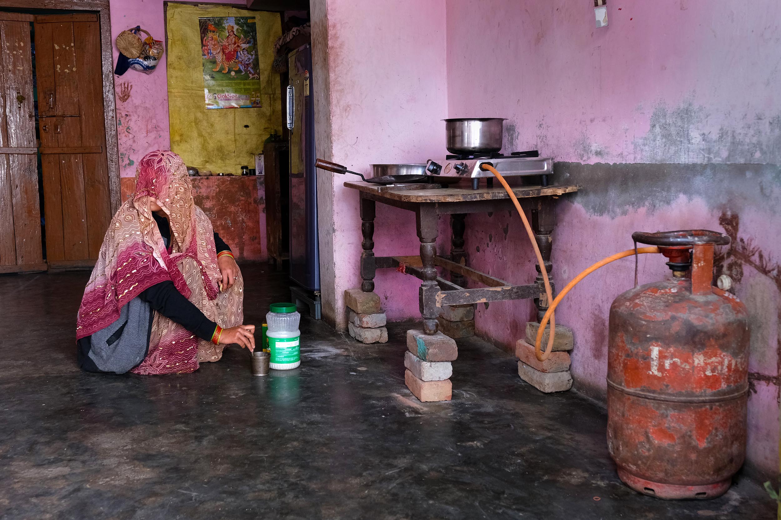 An Indian Oil Corp. Indane brand liquefied petroleum gas (LPG) cylinder is connected to a stove at a village home in Greater Noida, Uttar Pradesh, India, on Monday, Feb. 22, 2021. 