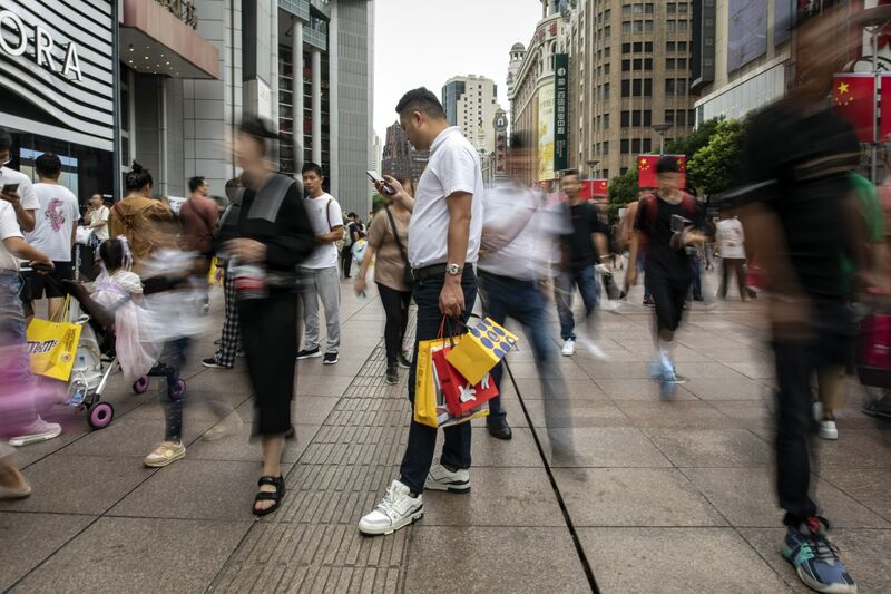 Pedestrians and shoppers on Nanjing Road shopping street in Shanghai, China