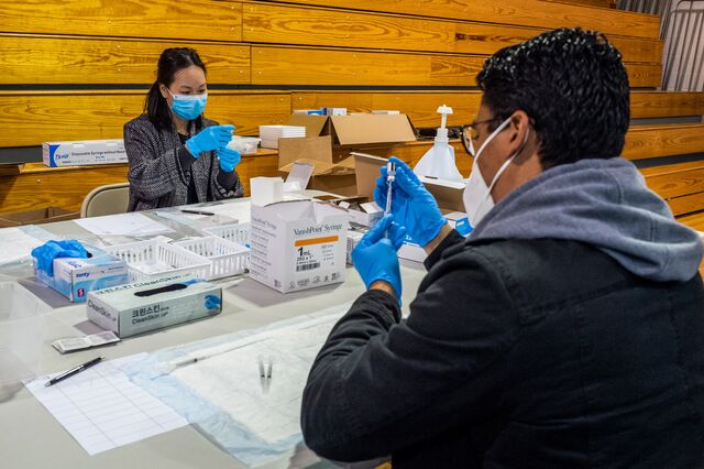 Pictured: Volunteers separate the Pfizer Covid-19 vaccine into individual doses in the gymnasium at the University of New Mexico's Gallup campus, which is hosting Covid-19 vaccinations through the Navajo Area Indian Health Service, on Mar. 23. Photographer: Cate Dingley/Bloomberg