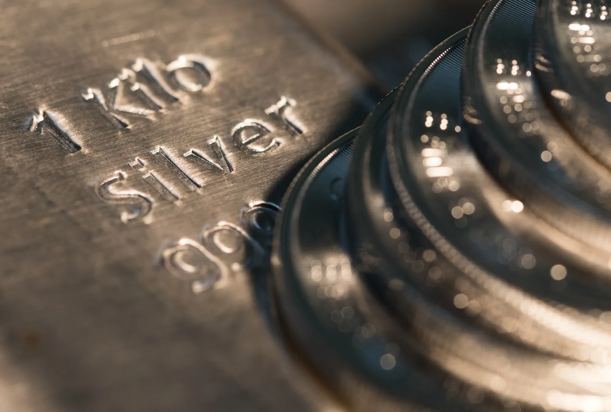 One-ounce silver coins sit on a one-kilogram silver bar at Gold Investments Ltd. bullion dealers in this arranged photograph in London, U.K., on Wednesday, July 29, 2020. Gold held its ground after a record-setting rally as investors awaited the outcome of a Federal Reserve meeting amid expectations policy makers will remain dovish, potentially spurring more gains.