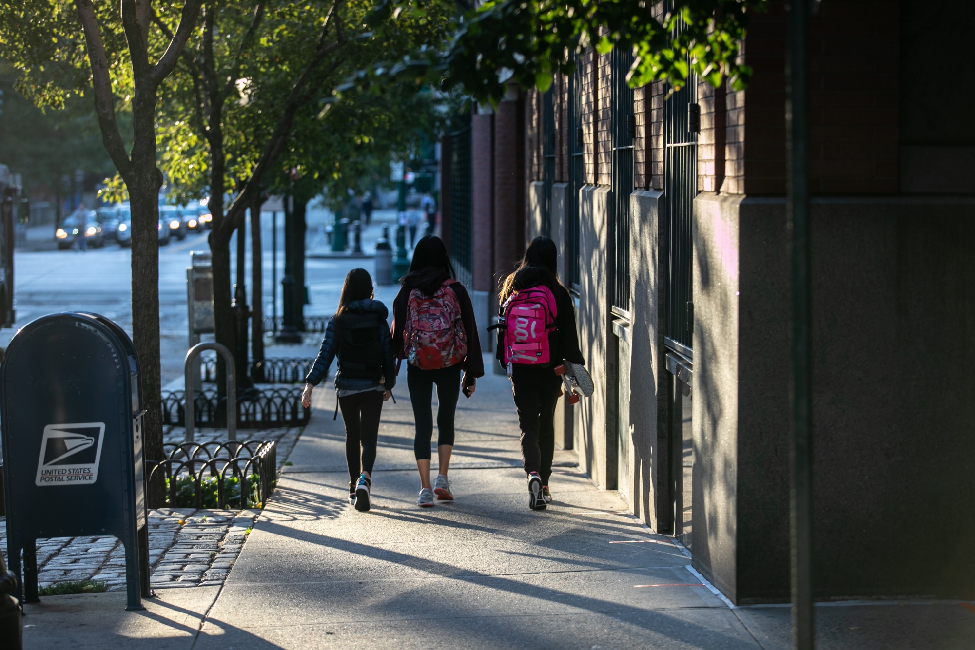 Students walk along a street in New York.