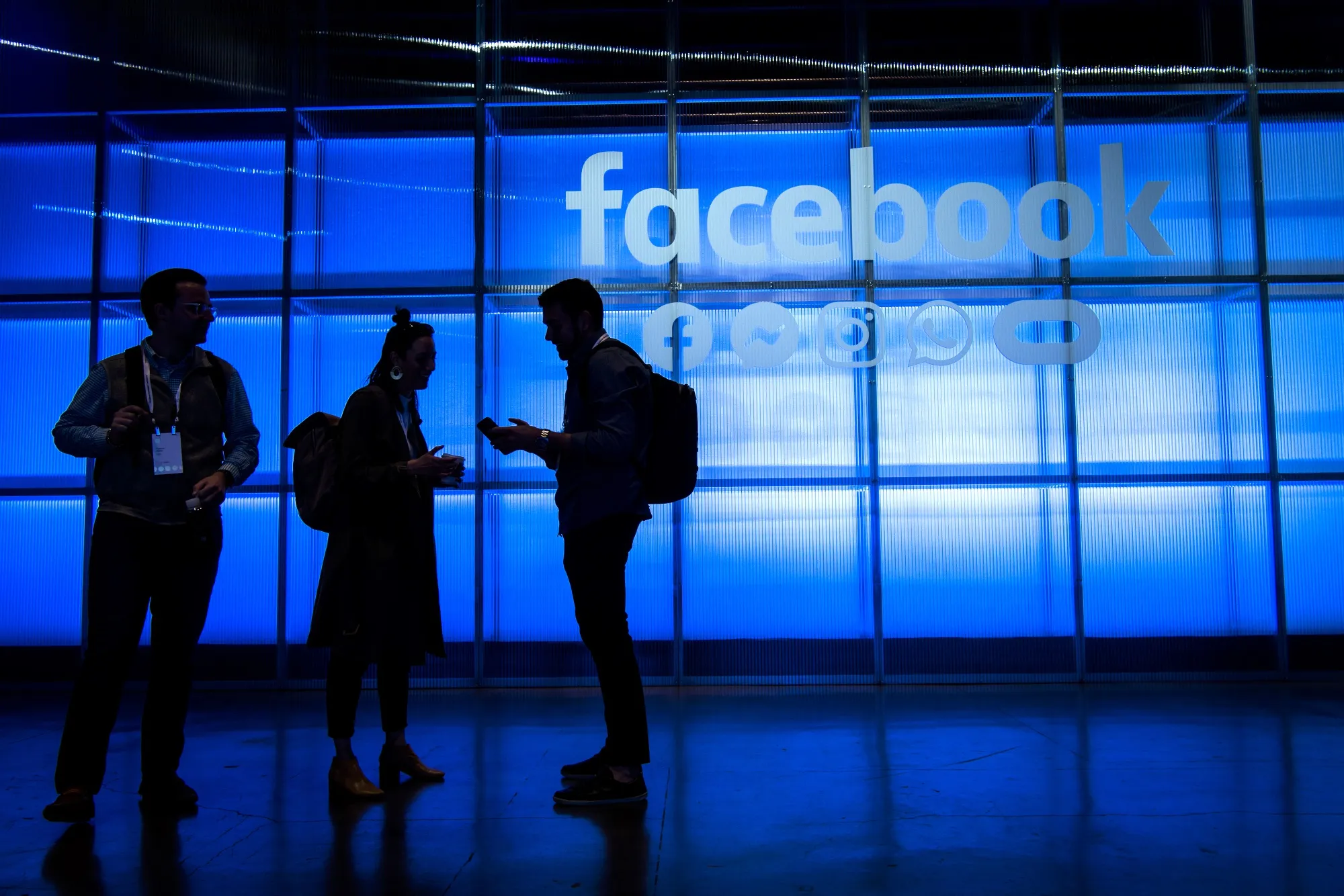 Attendees stand in the demonstration room during the F8 Developers Conference in San Jose.