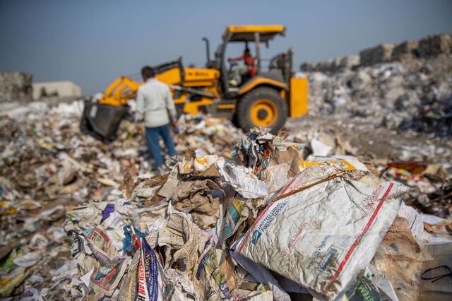 Stacks of imported raw materials containing a percentage of plastic waste including bags and covers of foreign brands are sorted at a yard prior to processing them  at Genus Paper & Boards Limited paper mill in Muzaffarnagar District, Uttar Pradesh, India, on Saturday, Nov. 19, 2022.