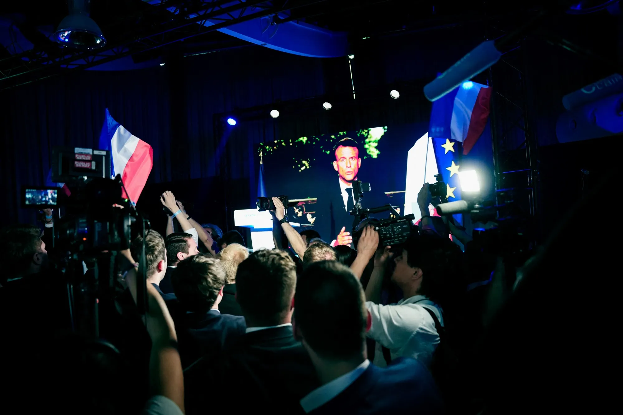 Supporters watch Emmanuel Macron during a National Rally event in Paris on June 9.