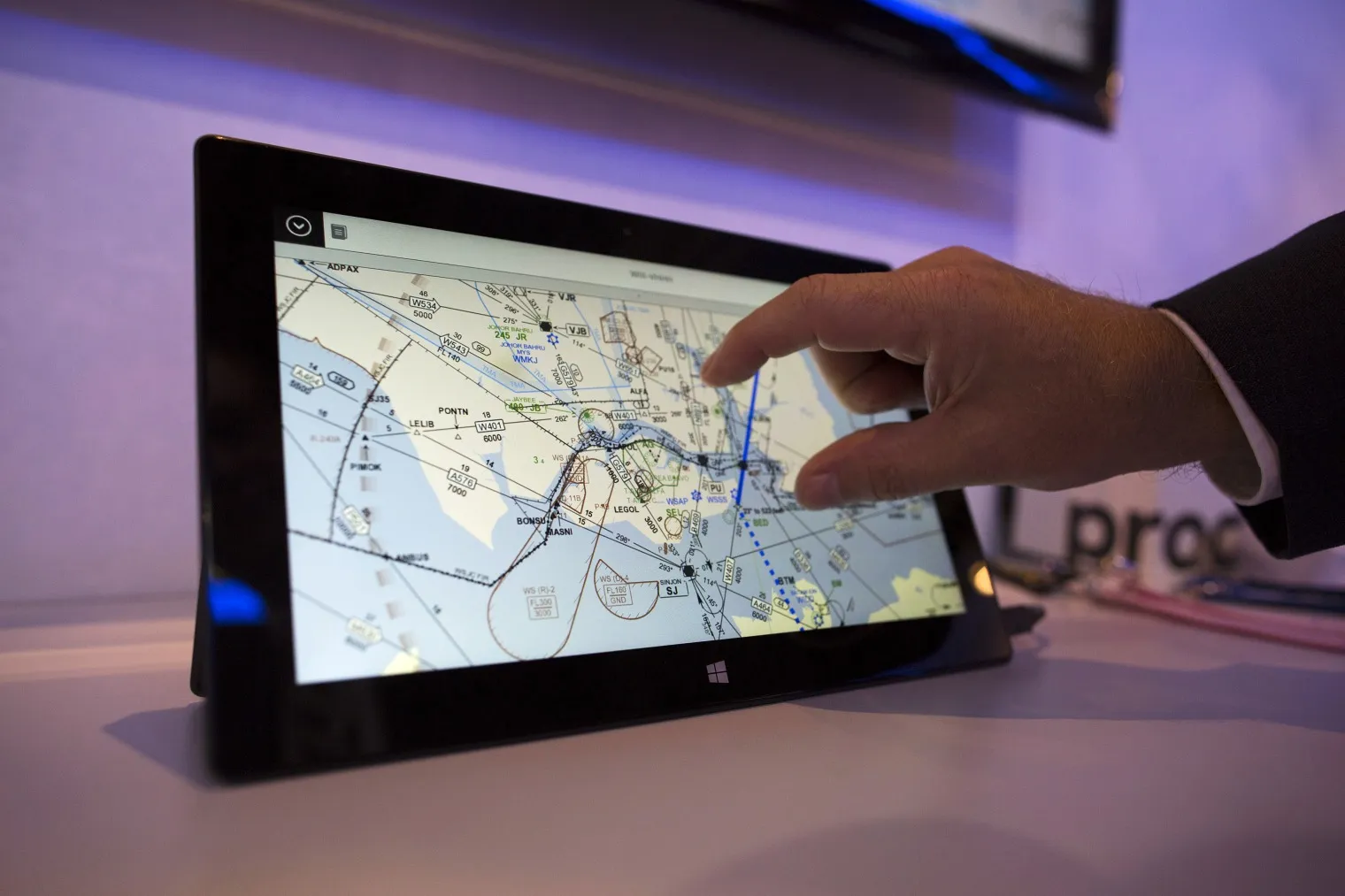 An attendant demonstrates a FliteDeck Pro application developed by Jeppesen.