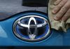 A Toyota Motor Corp. logo on a Prius PHV is polished on May 9, 2018.