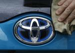 A Toyota Motor Corp. logo on a Prius PHV is polished on May 9, 2018.