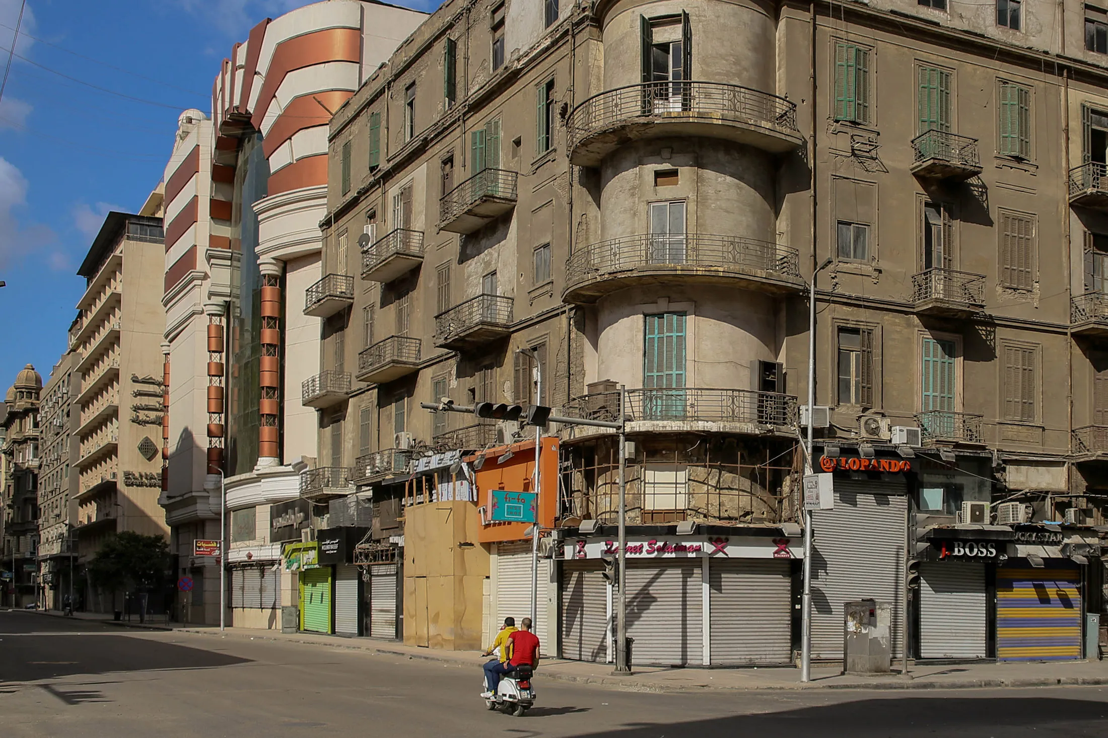People ride a scooter along the commercial Talaat Harb street in Cairo, Egypt, on May 24.
