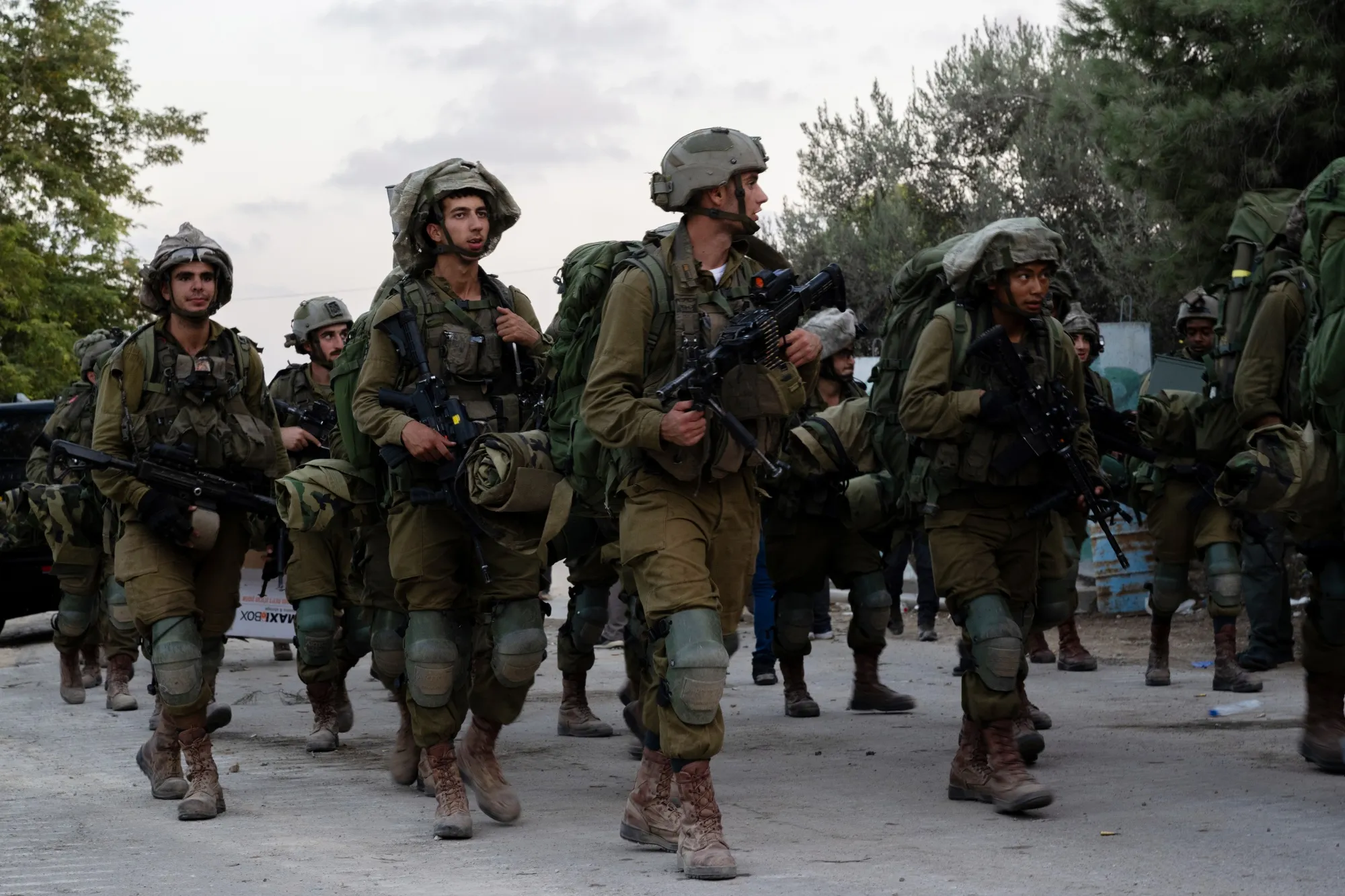 Israeli soldiers walk through Kibbutz&nbsp;Be'eri, Israel, on Oct. 11.