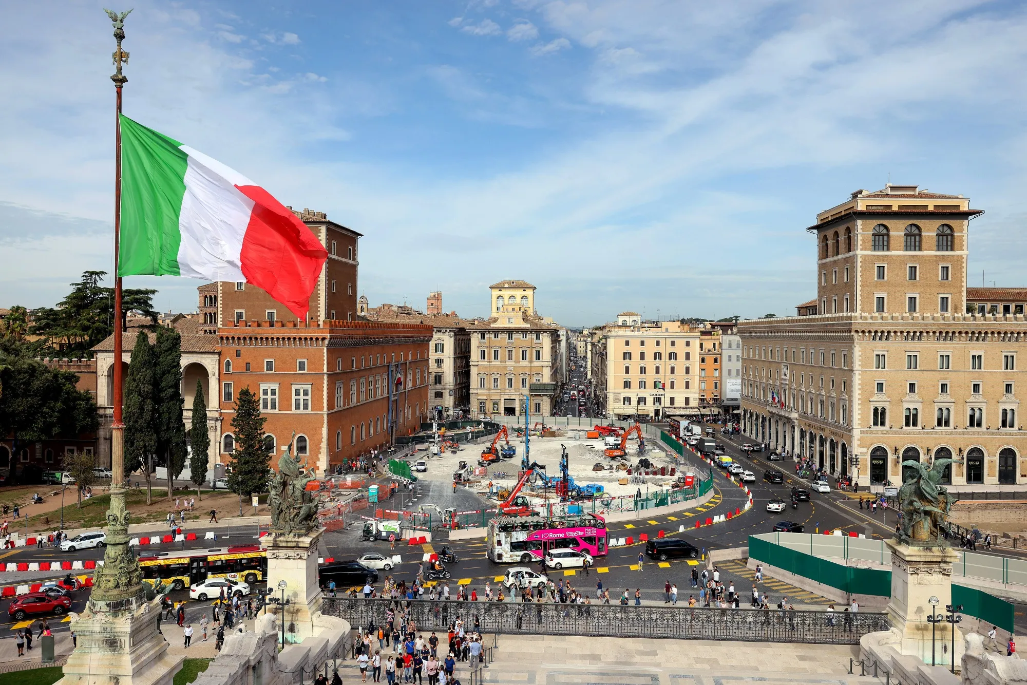 The Italian national flag flies near a monument to the unknown soldier overlooking a construction site for an underground station in Piazza Venezia in downtown Rome, Italy, on Monday, Oct. 30, 2023.