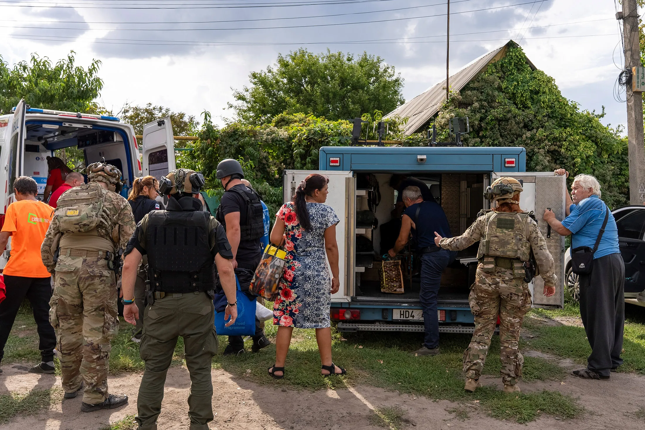 Policemen and medics help people to move from an armored car to a ambulance from the village of Yarova, that was hit by Russian aerial strike, which killed dozens of civilians, in Sloviansk, Donetsk region, on&nbsp;Sept. 9.