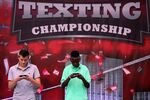Austin Wierschke (left) and Kent Augustine compete in the final round of the Sixth Annual LG Mobile U.S. National Texting Championships on August 8, 2012 in New York City.