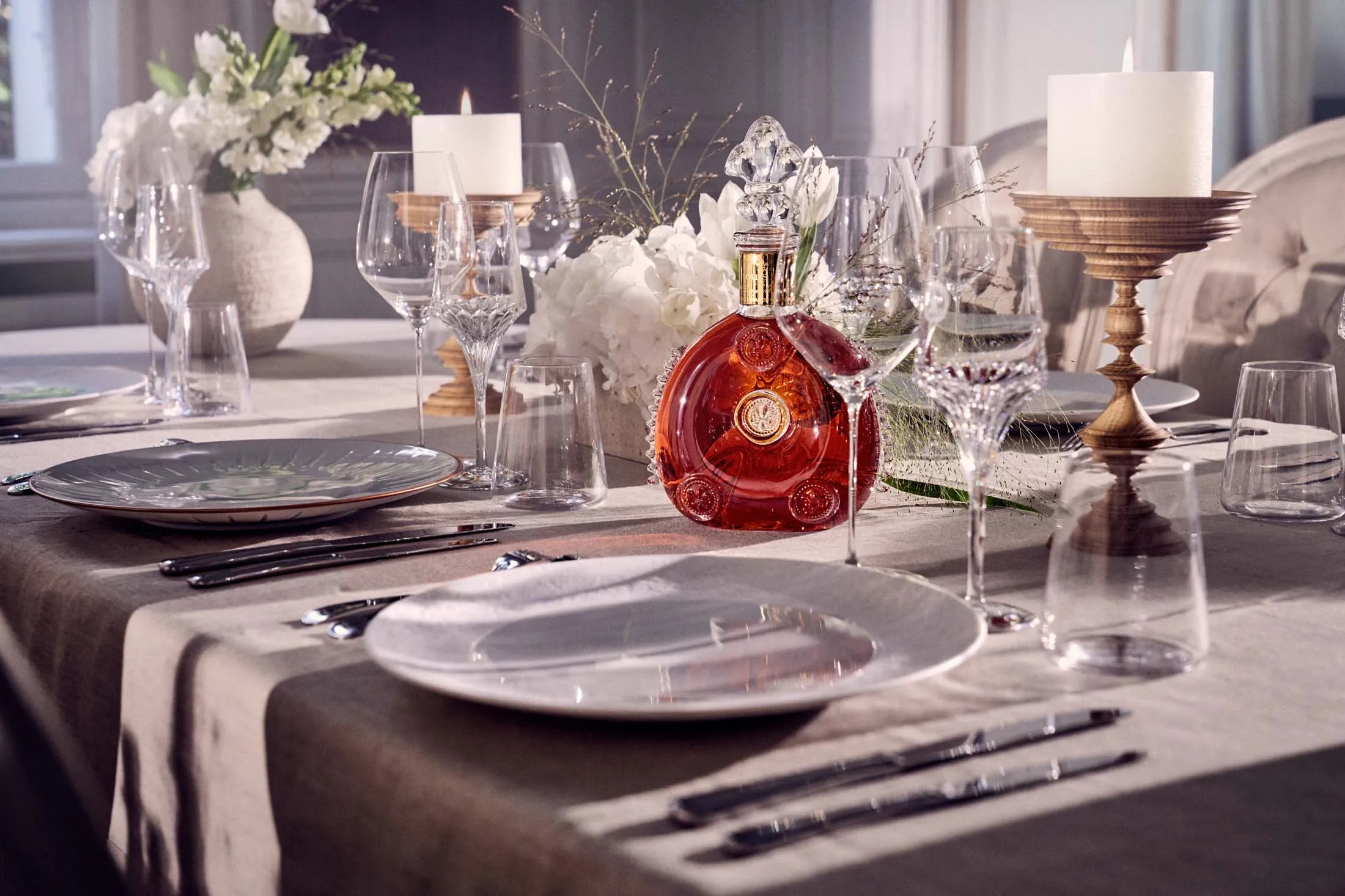 The classic Louis XIII Cognac decanter and its new Art de la Table plate collection.