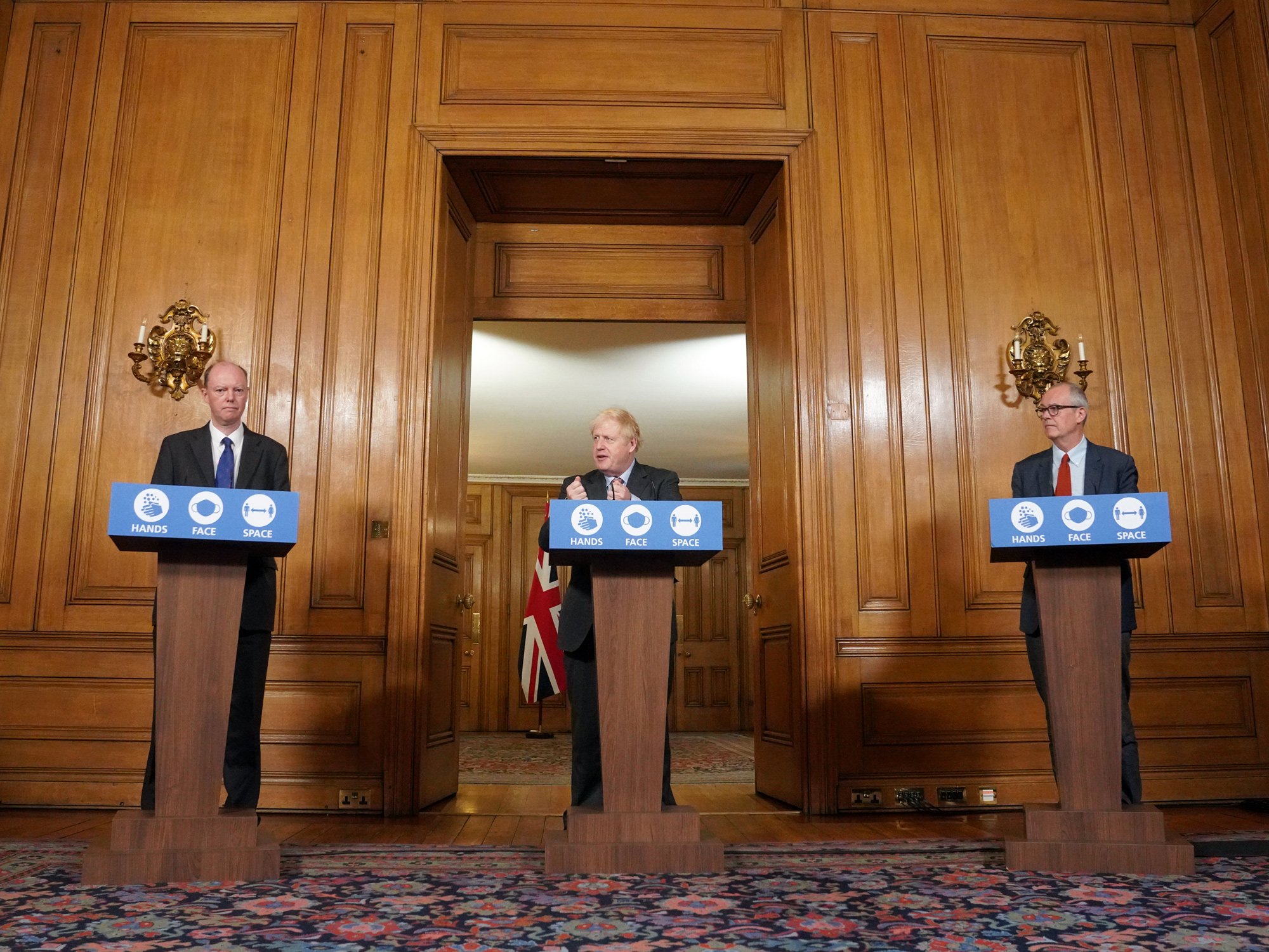 From left, Chris Whitty, Boris Johnson and Patrick Vallance attend a Covid-19 news conference in London on Sept. 30.