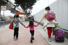 A migrant mother walks with children in Tijuana, Mexico.