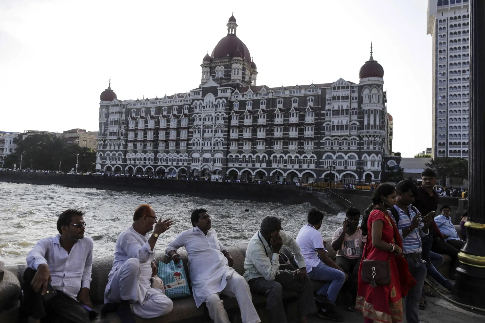 Tourists gather at the Gateway of India near the Taj Mahal Palace hotel in Mumbai. 