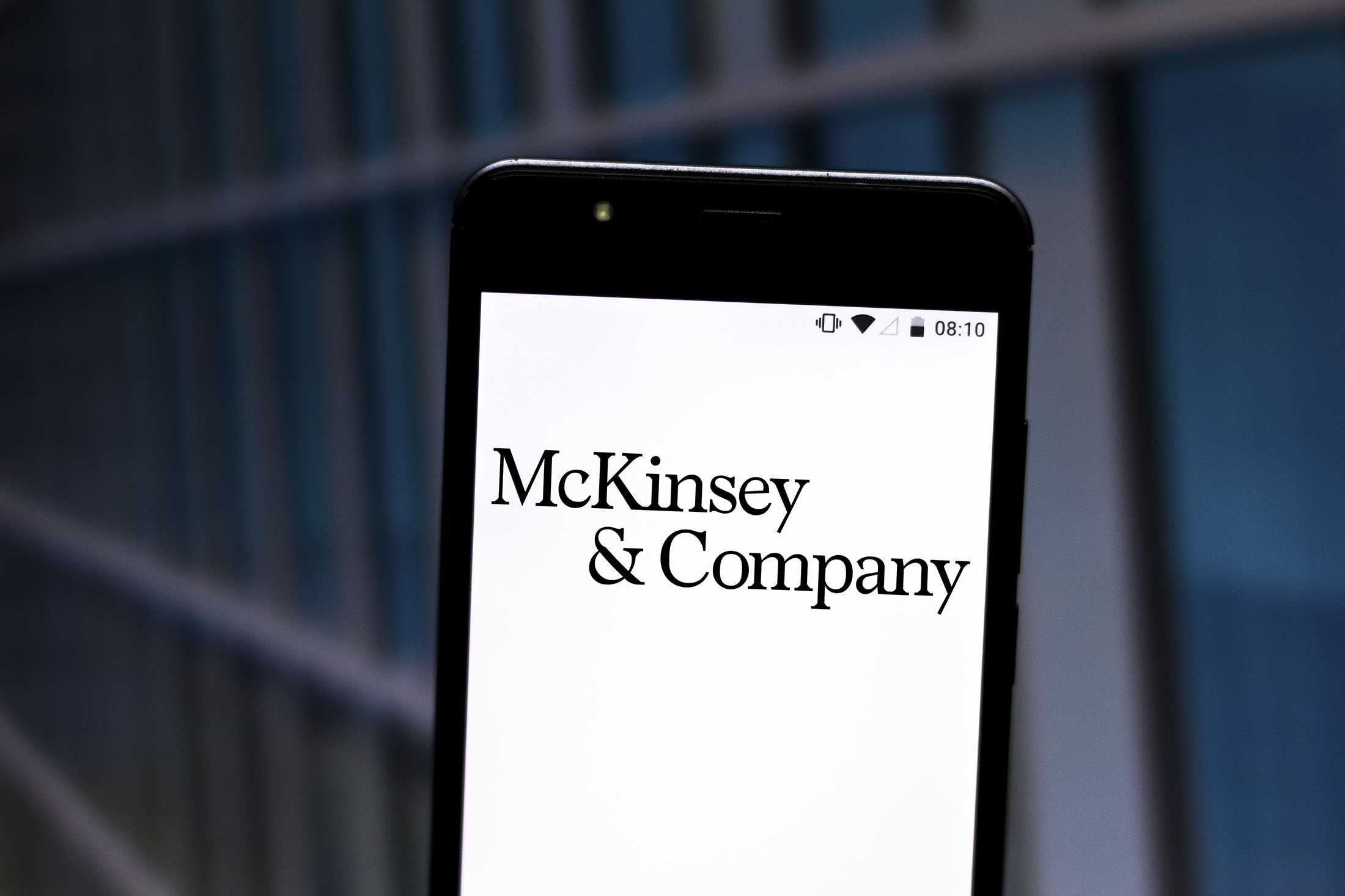 This photographic illustration shows a McKinsey & Company logo