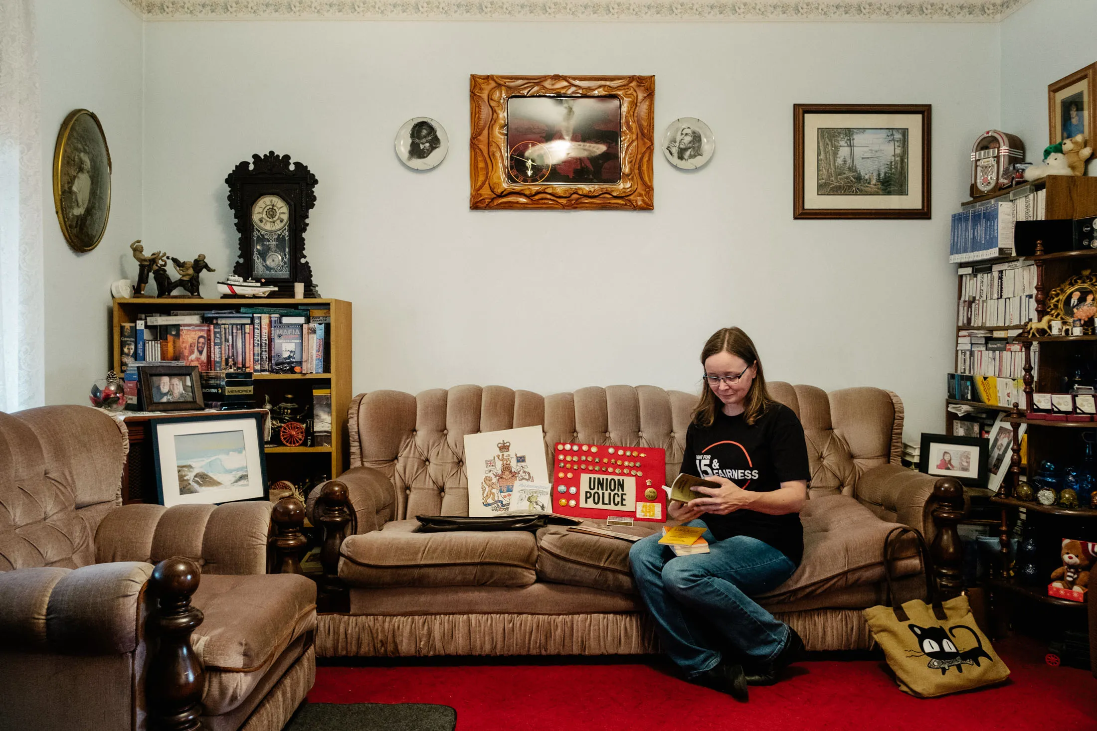 Rebecca Keetch, a GM production operator, looks at the ephemera her grandfather kept from the family’s time at GM, in Oshawa, Ontario, July 2019.