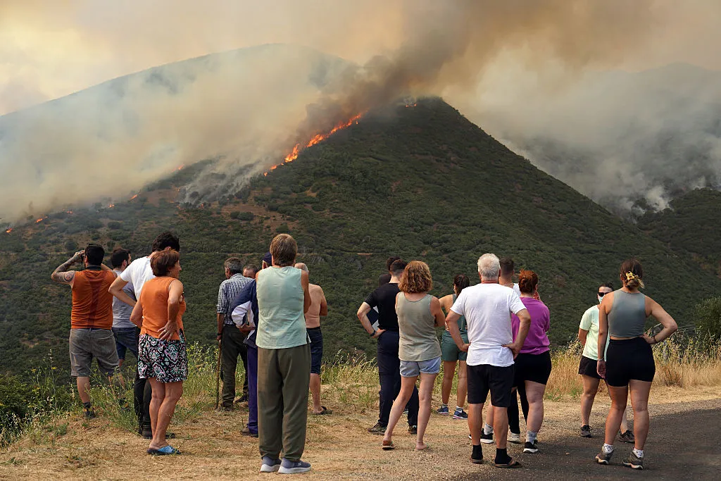 People watch a wildfire burning in Castrillo de Cabrera, northwestern Spain, on Aug. 16.