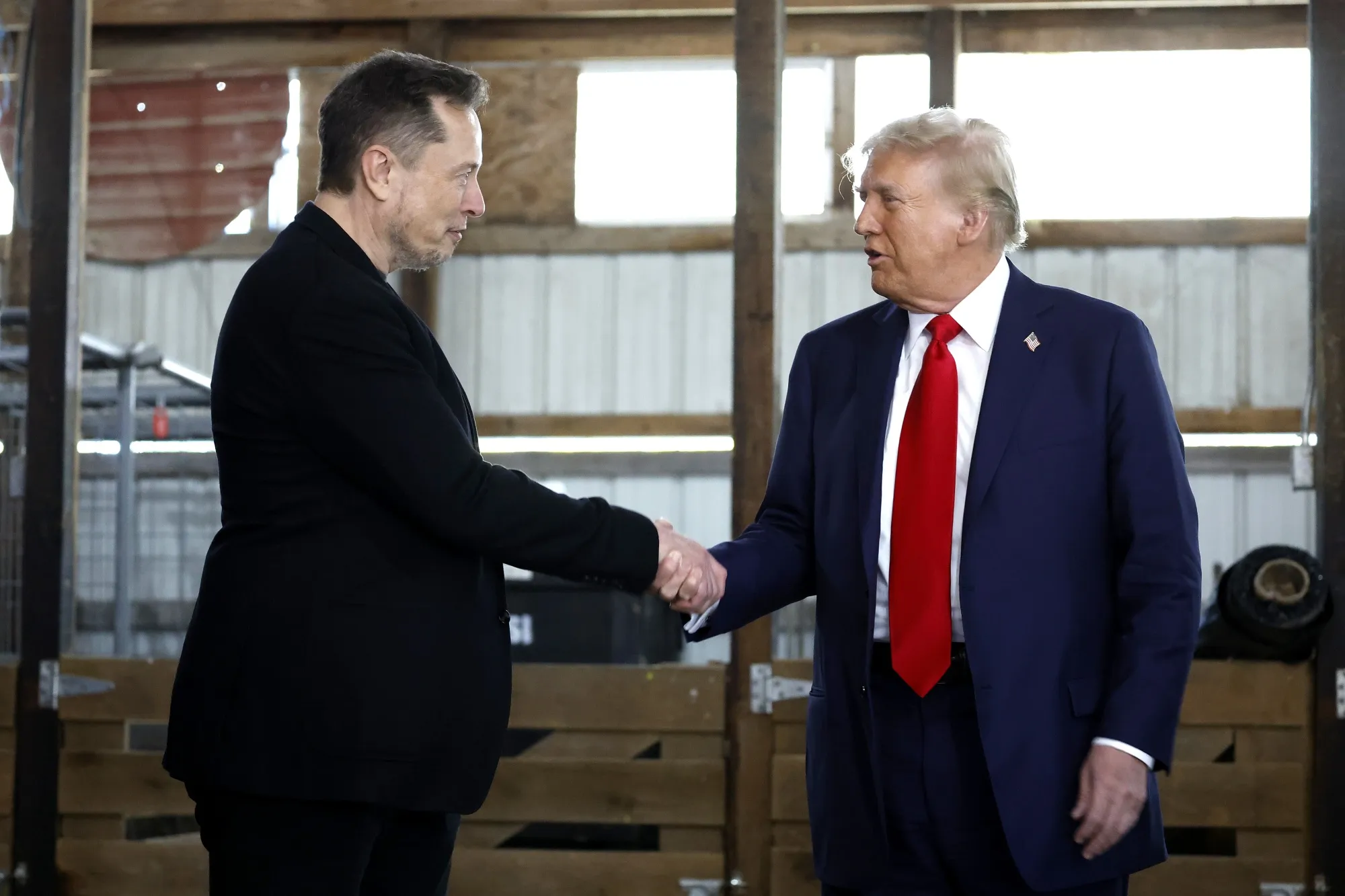 Elon Musk shakes hands with Donald Trump during a campaign rally in Butler, Pennsylvania, on Oct. 5.