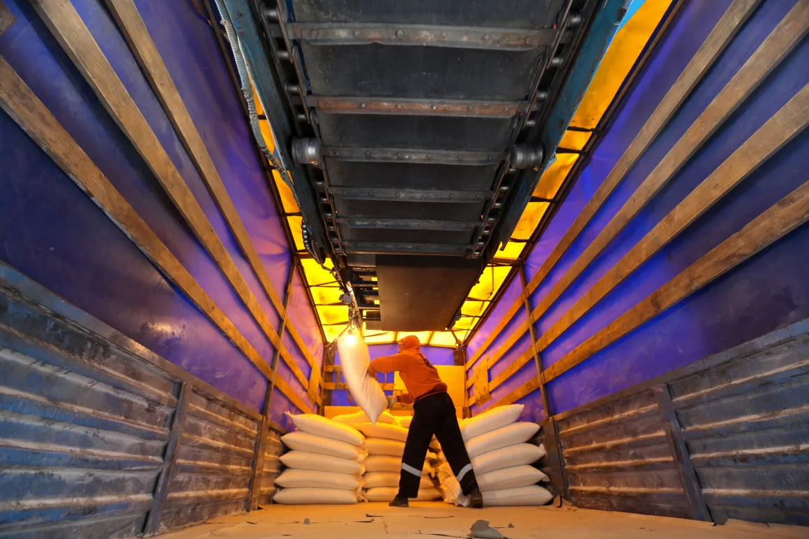 A worker stacks bags of sugar at a sugar production plant in Zainsk, Russia.