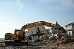 The remains of a house are cleared in the Rockaways area of New York in November 2012.
