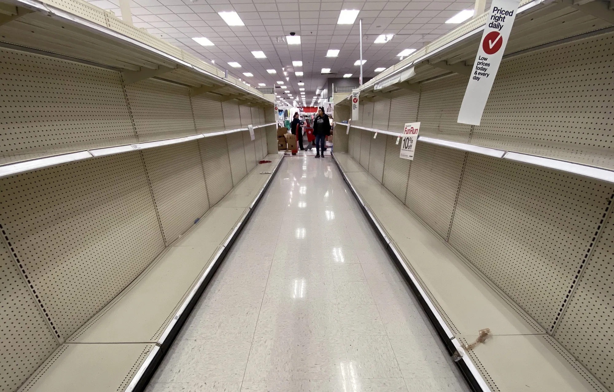 Shelves normally stocked with hand wipes, hand sanitizer and toilet paper sit empty at a Target store in Arlington, Virginia, on March 13, 2020.