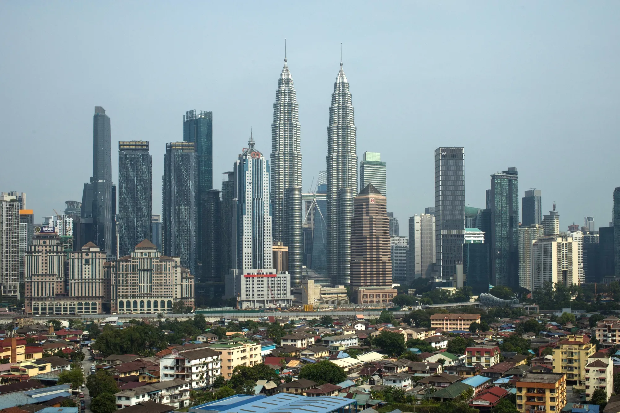 The Petronas Twin Towers, center, and other buildings in Kuala Lumpur, Malaysia, on Friday, July 25, 2025. Malaysia's economy grew faster than expected in the second quarter, driven by the services sector, even as the country contends with US President Donald Trump’s rollout of global tariffs.
