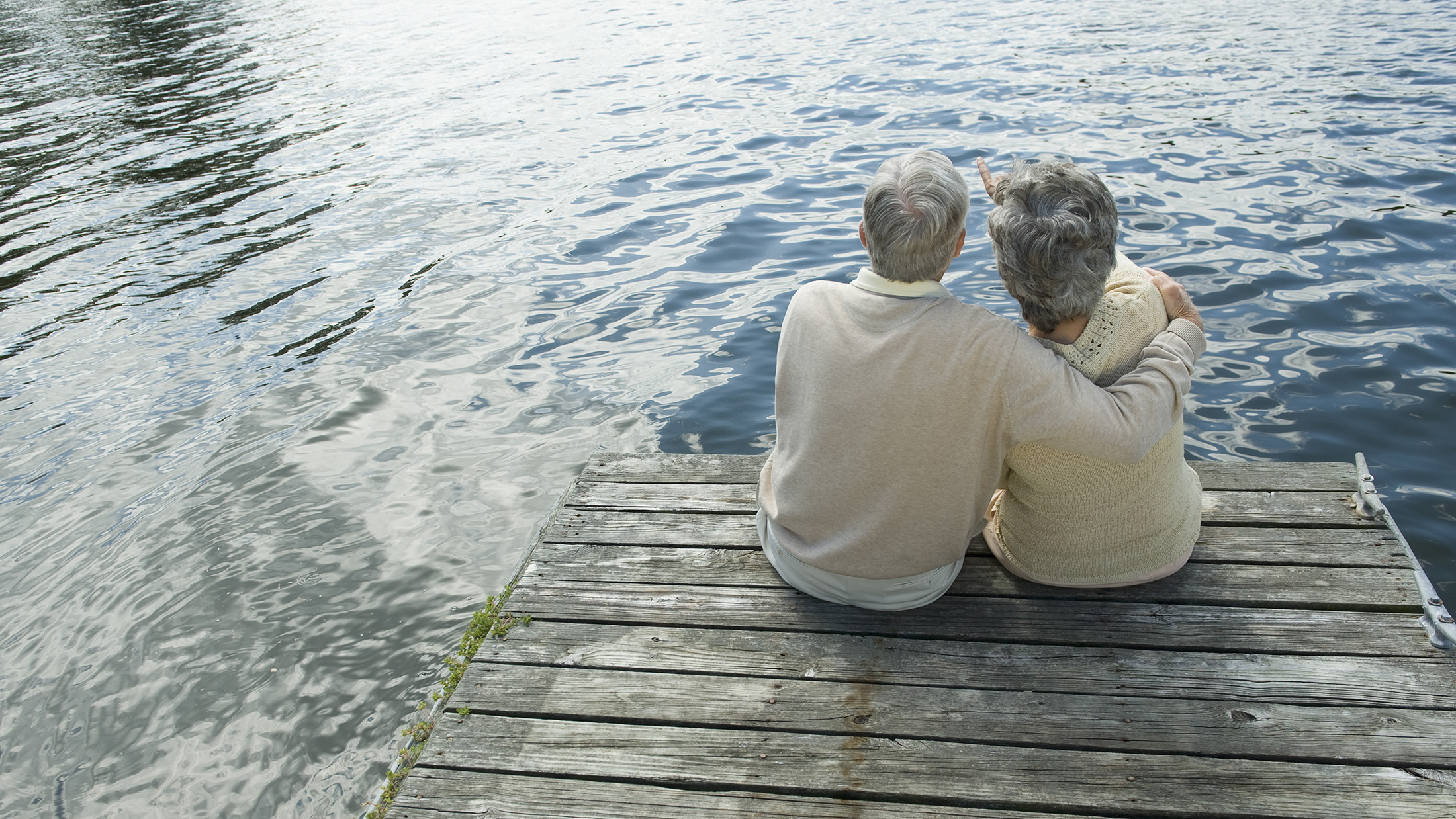 Senior couple hugging on dock
