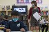 A teacher walks around the classroom during a lesson at an elementary school in San Francisco, on Oct. 5, 2020.