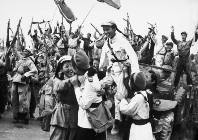 North Korean and Chinese troops celebrate after driving back an attack of US forces in June 1950.