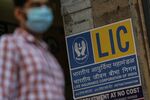 A pedestrian passes a Life Insurance Corp. of India branch office in Mumbai, India,.