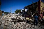 A person inspects rubble and destroyed power lines in Guayanilla, Puerto Rico, on Jan. 12.