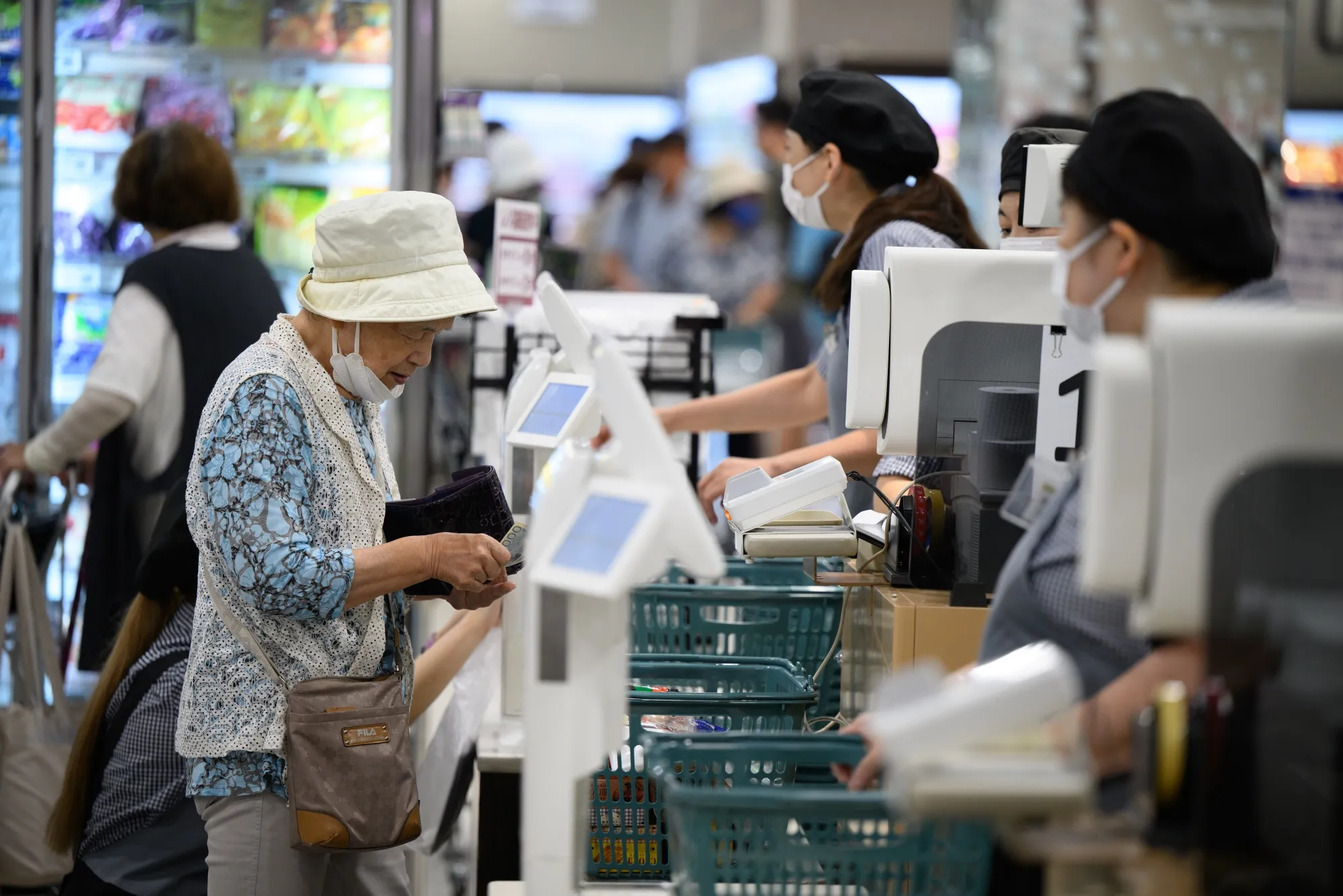 A customer pays a cashier at a&nbsp;supermarket&nbsp;in Tokyo, Japan.