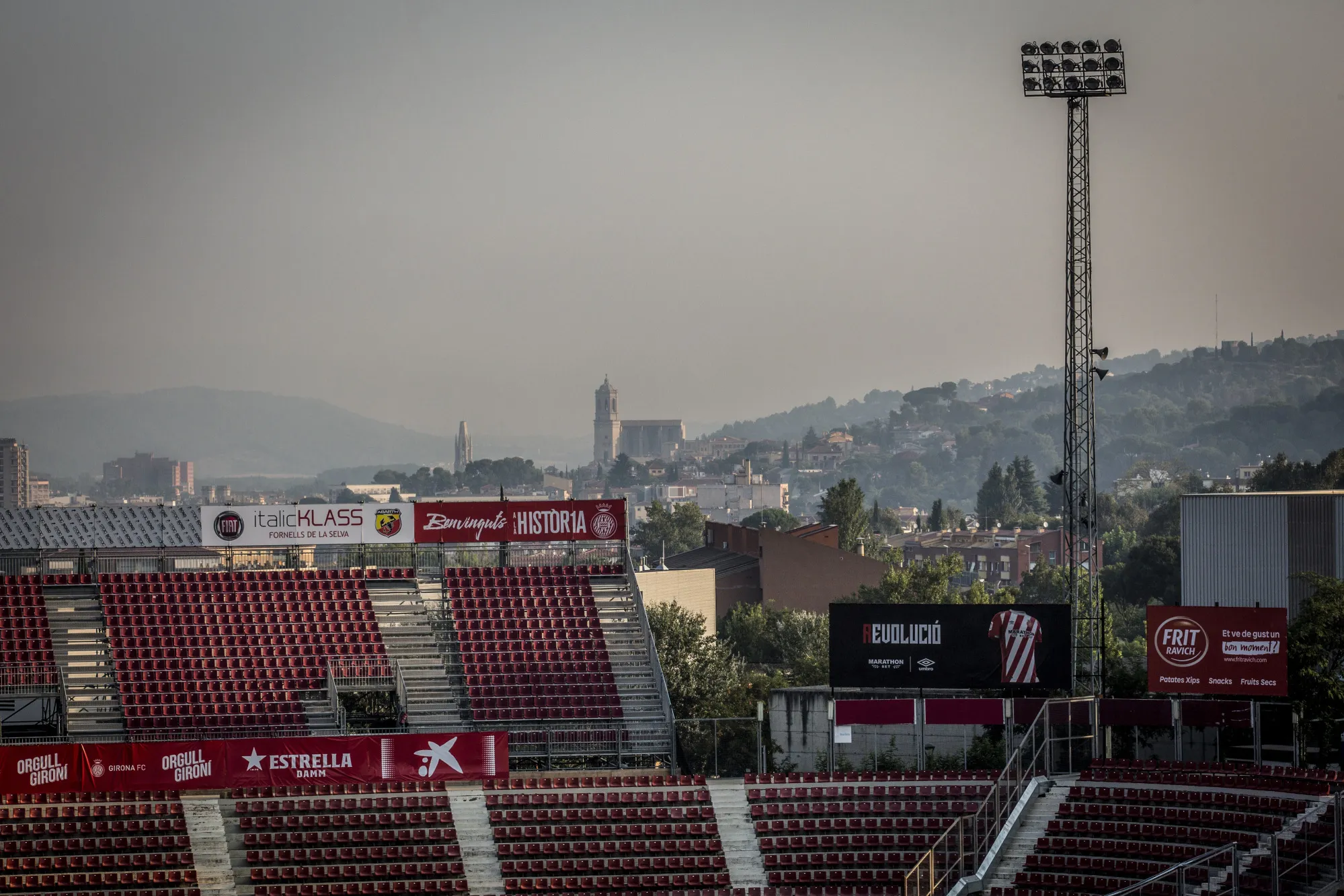 The old town of Girona stands beyond Estadi Montilivi, home stadium of Girona Futbol Club.